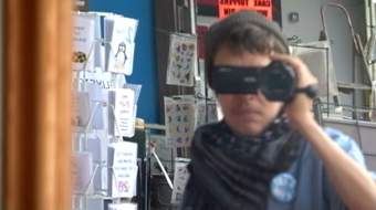 Reflection of person holding a camcorder in the mirror